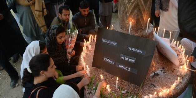 Pakistani civil society activists light candles a day after an attack on an army-run school by Taliban militants in Peshawar on December 17, 2014. Pakistan began three days of mourning on December 17 for the 132 schoolchildren and nine staff killed by the Taliban in the country's deadliest ever terror attack as the world united in a chorus of revulsion. AFP PHOTO / A MAJEED (Photo credit should read A Majeed/AFP/Getty Images)