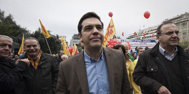 ATHENS, GREECE - NOVEMBER 27: Leader of the main opposition party, leftist Alexis Tsipras (C) is seen when thousands of Greeks march in central Athens during a protest rally against a new bout of austerity in a 24-hour general strike on November 27, 2014. (Photo by Socrates Baltagiannis/Anadolu Agency/Getty Images)