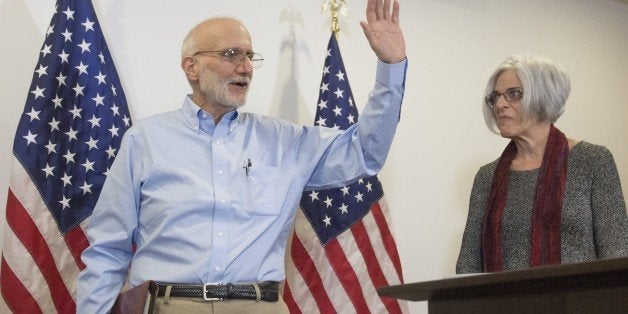 Alan Gross, alongside his wife Judy, leaves a press conference after being released by Cuba on December 17, 2014 in Washingto