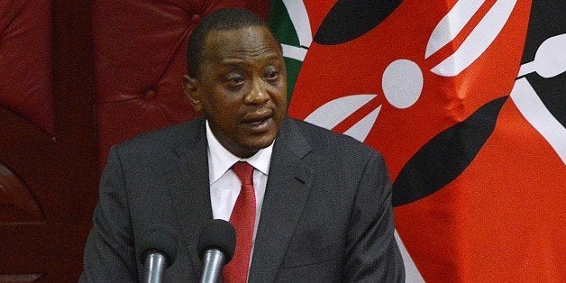 Kenyan President Uhuru Kenyatta addresses a special legislative session in parliament in Nairobi on October 6, 2014. Kenyatta said he will go to the International Criminal Court, where he faces charges of crimes against humanity, becoming the first sitting president to appear. Kenyatta, 52, faces five counts at the ICC over his alleged role in masterminding post-election violence in 2007 and 2008 that left 1,200 people dead and 600,000 displaced. AFP PHOTO/ SIMON MAINA (Photo credit should read SIMON MAINA/AFP/Getty Images)