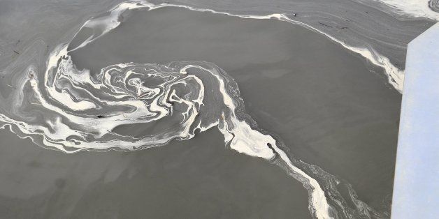 A vortex of coal ash swirls in the gray waters of the Dan River at Danville, Va. downstream from the Duke Energy Steam Station in Eden, NC. (John D. Simmons/Charlotte Observer/MCT via Getty Images)