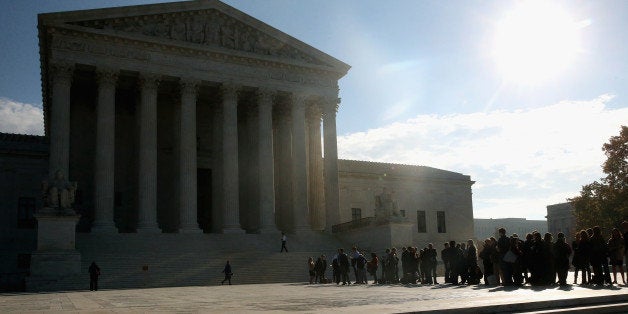 WASHINGTON, DC - NOVEMBER 12: People stand in line to enter the US Supreme Court building, November 12, 2014 in Washington, DC. Today the high court will hear oral arguments for cases, Alabama Legislative Black Caucus v. Alabama, Alabama Democratic Conference v. Alabama, and Comptroller of Treasury of Maryland v. Wynne. (Photo by Mark Wilson/Getty Images)