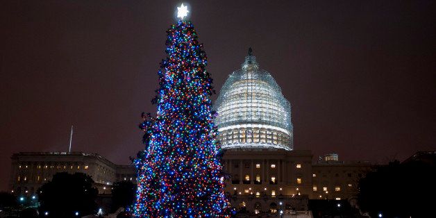 WASHINGTON, DC - DECEMBER 2: Speaker of the House, John Boehner (R-OH), assisted by Aaron Urban, 10, of Linthicum, MD, threw the switch to light the Capitol Christmas Tree in front of the U.S. Capitol on December 2, 2014 in Washington, DC. Urban, who is fighting brain cancer, is helping light the tree as the kickoff for his one-true-wish, being granted by Make-A-Wish Mid-Atlantic, to spend Christmas in New York City. The tree is an 88-foot white spruce from the Chippewea National Forest in Cass Lake, Minnesota. (Photo by Pete Marovich/Getty Images)