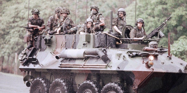 A light armored vehicle providing security for a convoy of vehicles, Saturday, May 13, 1989 in Panama. Nearly 2000 new troops have been deployed to Panama to provide security for American personnel and property. President George Bush Saturday urged the Panamanian people and the Defense Forces to force General Noriega from power. (AP Photo/John Hopper)