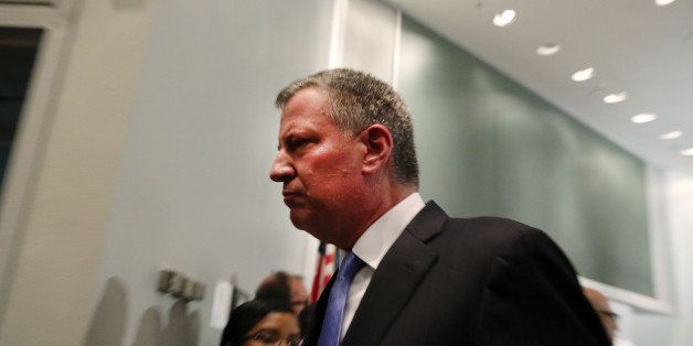NEW YORK, NY - DECEMBER 20: New York Mayor Bill de Blasio leaves a news conference at Woodhull Hospital following the killing of two New York City police officers on December 20, 2014 in New York City. The officers were killed execution style Saturday afternoon as they sat in their marked police car on a Brooklyn street corner. The suspect, who killed his girlfriend in Baltimore earlier in the day, was apparently motivated by the deaths of Eric Garner and Michael Brown. (Photo by Spencer Platt/Getty Images)