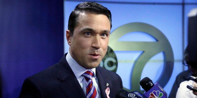 Incumbent Republican Rep. Michael Grimm answers reporters' questions after a recorded, televised debate for the 11th Congressional District race with his Democratic challenger Domenic Recchia, Friday, Oct. 17, 2014, at WABC-TV in New York. (AP Photo/Richard Drew)
