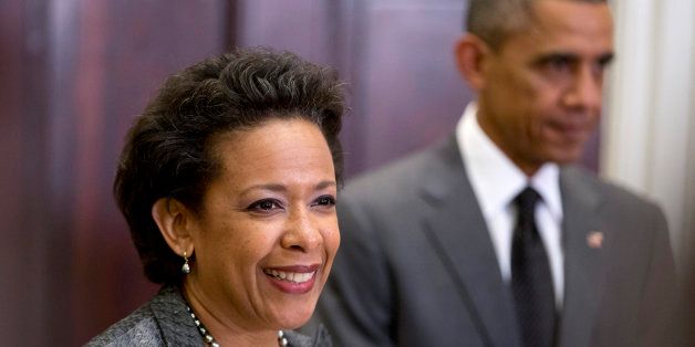 President Barack Obama listens at right as US Attorney Loretta Lynch speaks in the Roosevelt Room of the White House in Washington, Saturday, Nov. 8, 2014, where the president announced he would nominate Lynch to replace Attorney General Eric Holder. (AP Photo/Carolyn Kaster)