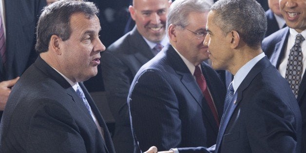 US President Barack Obama shakes hands with New Jersey Governor Chris Christie (L) after speaking to US troops at Joint Base
