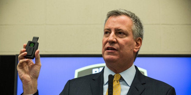 NEW YORK, NY - DECEMBER 03: New York City Mayor Bill de Blasio holds up a body camera that the New York Police Department (NYPD) will begin using during a press conference on December 3, 2014 in New York City. The NYPD is beginning a trial exploring the use of body cameras; starting Friday NYPD officers in three different precincts will begin wearing body cameras during their patrols. (Photo by Andrew Burton/Getty Images)