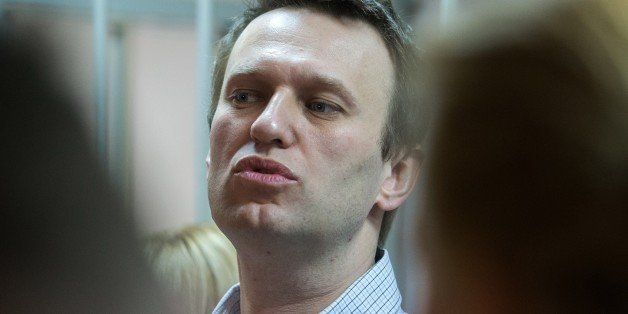 Russian anti-Kremlin opposition leader Alexei Navalny speaks as he attends the verdict announcement of his fraud trial at a court in Moscow on December 30, 2014. Russia's top opposition leader Alexei Navalny on December 30 called for mass protests to 'destroy' President Vladimir Putin's regime after a court handed him a suspended sentence but jailed his brother in a controversial fraud case. In a lightning hearing that was abruptly brought forward by two weeks, a judge found both Navalny and his brother Oleg guilty of embezzlement and sentenced the siblings to three and a half years in what is widely seen as a politically motivated case. AFP PHOTO / DMITRY SEREBRYAKOV (Photo credit should read DMITRY SEREBRYAKOV/AFP/Getty Images)