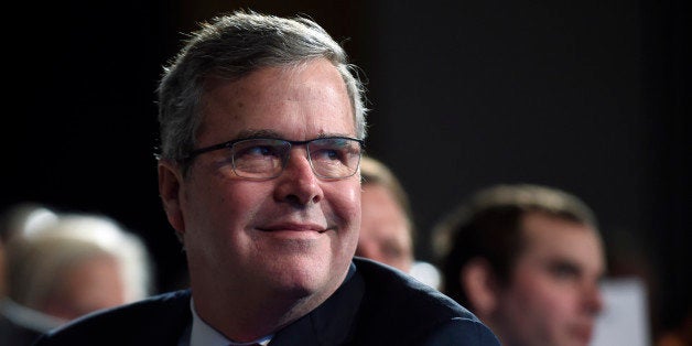 Former Florida Gov. Jeb Bush listens to a speaker before giving his keynote address at the National Summit on Education Reform in Washington, Thursday, Nov. 20, 2014. (AP Photo/Susan Walsh)