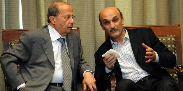 Lebanese opposition leader Michel Aoun (L) speaks with Lebanese Forces' executive committee chief, Samir Geagea at Beirut International Airport on May 16, 2008 on their way to a meeting of Lebanese leaders in Doha. Lebanon's squabbling political leaders were to meet in Qatar today for talks brokered by the Arab League aimed at ending a long-running feud that drove the country to the brink of a new civil war. AFP PHOTO/STR (Photo credit should read -/AFP/Getty Images)