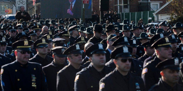 File-This Dec. 27, 2014, file photo shows police officers turning their backs as New York City Mayor Bill de Blasio speaks at the funeral of New York city police officer Rafael Ramos in the Glendale section of Queens, in New York. Mayor Bill de Blasio is winding down his first year in office, which saw success at fulfilling many of his liberal campaign promises. But the year ends with his young mayoralty facing its biggest crisis yet: an open rebellion from police officers who donât believe the mayor supports them. (AP Photo/John Minchillo)