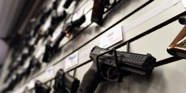 Handguns are displayed at the Ultimate Defense Firing Range and Training Center in St Peters, Missouri, some 20 miles (32 kilometers) west of Ferguson, on November 26, 2014. Paul Bastean, owner of the range, told AFP that business had grown as a result of anxiety about reaction to the jury announcement in the shooting death of 18-year-old Michael Brown. Typical sales of five to seven guns a day have risen to 20 to 30 in the last week, while gun-handling courses for November and December are fast selling out. Violence erupted in the St Louis, Missouri suburb for a second night on November 25 over the decision by a grand jury not to prosecute a white police officer for shooting dead Brown, an unarmed black teenager. AFP PHOTO/Jewel Samad (Photo credit should read JEWEL SAMAD/AFP/Getty Images)