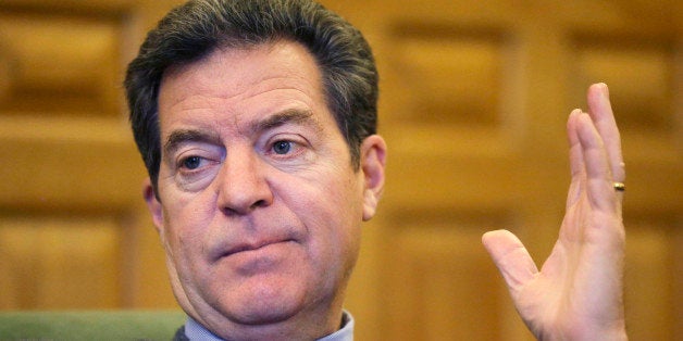 Kansas Gov. Sam Brownback responds to a reporter's question during an interview with The Associated Press at his office in th