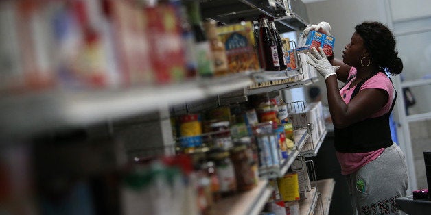 SAN FRANCISCO, CA - MAY 01: A worker stocks shelves with canned goods at the SF-Marin Food Bank on May 1, 2014 in San Francisco, California. Food banks are bracing for higher food costs and an increased demand for food from the needy as food prices are skyrocketing due to a reduction in food stamps and drought conditions in several states. (Photo by Justin Sullivan/Getty Images)