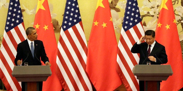 U.S. President Barack Obama, left, and Chinese President Xi Jinping arrive for their joint press conference at the Great Hall of the People in Beijing Wednesday, Nov. 12, 2014. (AP Photo/Andy Wong)