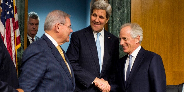 UNITED STATES - DECEMBER 9: From left, chairman Bob Menendez, D-N.J., Secretary of State John Kerry and ranking member Bob Corker, R-Tenn., arrives for the Senate Foreign Relations Committee hearing on 'Authorization for the Use of Military Force Against ISIL' on Tuesday, Dec. 9, 2014. (Photo By Bill Clark/CQ Roll Call)