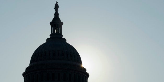 The sun peeks from behind the Capitol dome on Capitol Hill in Washington, Friday, Oct. 4, 2013, as the budget battle continues. President Barack Obama decided to stay home from economic summits in Asia as Democrats stepped up pressure on congressional Republicans to rein in their tea party faction and reopen the government with no strings attached. (AP Photo/Susan Walsh)