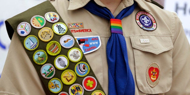 The Boy Scout uniform of Pascal Tessier, 17, a gay Eagle Scout from Kensington, Md., includes his merit badges and a rainbow-colored neckerchief slider, as he speaks in front of a group of Boy Scouts and scout leaders, Wednesday, May 21, 2014, outside the headquarters of Amazon.com in Seattle. The group delivered a petition to Amazon that was started as an online effort by Tessier and gathered more than 125,000 signatures, urging Amazon to stop donating money to the Boy Scouts due to the organization's policy of excluding openly gay adults from leadership positions, despite recently accepting gay youth as scouts. (AP Photo/Ted S. Warren)