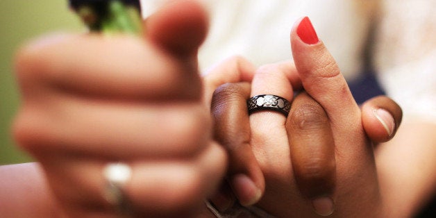 NEW YORK, NY - JUNE 27: U.S. Air Force Senior Airman Shyla Smith and Courtney Burdeshaw hold hands while waiting to get married at the Manhattan Marriage Bureau the day after the U.S. Supreme Court ruling on DOMA on June 27, 2013 in New York City. The high court struck down the Defense of Marriage Act (DOMA) and ruled that supporters of California's ban on gay marriage, Proposition 8, could not defend it before the Supreme Court. The pair said they planned to get married today before the ruling came down. (Photo by Mario Tama/Getty Images)