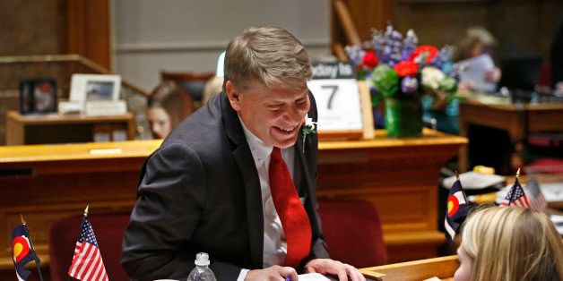New Colorado State Senate Majority Leader Mark Scheffel, R-Parker, speaks with his daughter Maria, a guest, during a recess in the opening session of the 2015 Colorado Legislature, at the Capitol, in Denver, Wednesday Jan. 7, 2015. Republicans have control of the Senate for the first time in a decade. (AP Photo/Brennan Linsley)