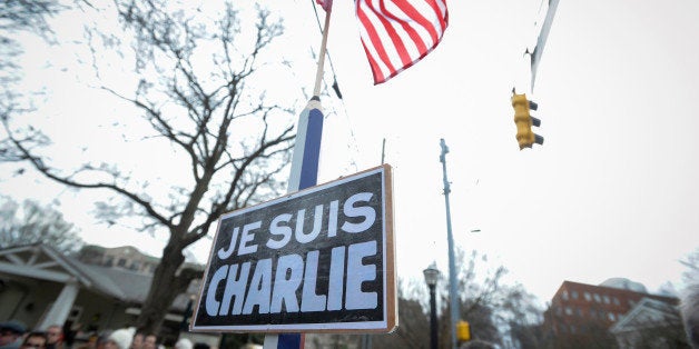 A sign reading "Je Suis Charlie" (I am Charlie) is on display during a silent walk in Atlanta, Sunday, Jan. 11, 2015, to supp