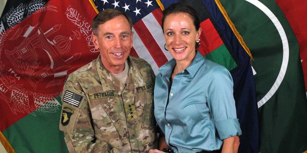 FOR USE AS DESIRED, YEAR END PHOTOS - FILE - This July 13, 2011 file photo, made available on the International Security Assistance Force's Flickr website shows the former Commander of International Security Assistance Force and U.S. Forces-Afghanistan Gen. Davis Petraeus, left, shaking hands with Paula Broadwell, co-author of "All In: The Education of General David Petraeus." Petraeus resigned as CIA director over his extramarital affair with his biographer, Broadwell. (AP Photo/ISAF, File)
