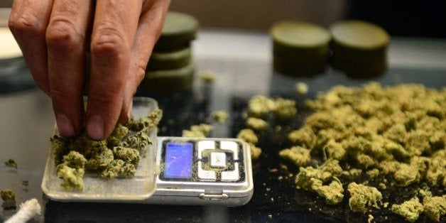 A vendor weighs buds for card-carrying medical marijuana patients attending Los Angeles' first-ever cannabis farmer's market at the West Coast Collective medical marijuana dispensary, on the fourth of July, or Independence Day, in Los Angeles, California on July 4, 2014 where organizer's of the 3-day event plan to showcase high quality cannabis from growers and vendors throughout the state. AFP PHOTO/Frederic J. BROWN (Photo credit should read FREDERIC J. BROWN/AFP/Getty Images)