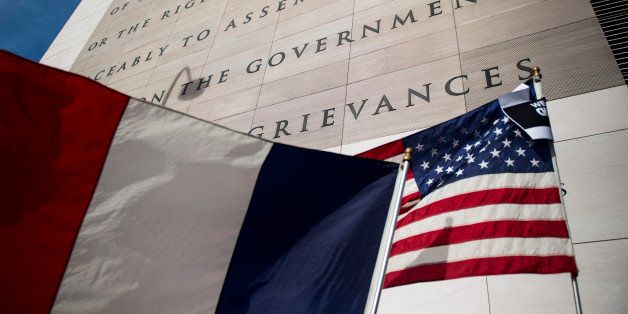 WASHINGTON, DC - JANUARY 11: The French and American flags wave in front of the Newseum's First Amendment tablet during the Unity Rally on January 11, 2015 in Washington, D.C. The Unity Rally, held around the world, follows the terrorist attack at the French satirical magazine Charlie Hebdo in Paris, France, leaving 12 dead and making it the deadliest attack in recent French history. (Photo by Gabriella Demczuk/Getty Images)