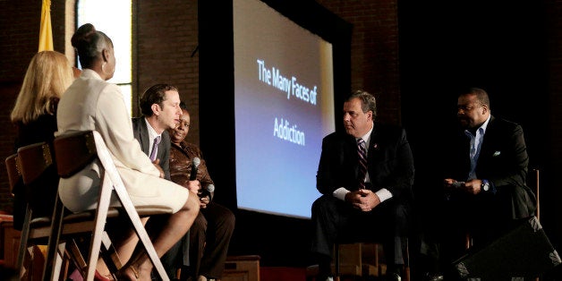 New Jersey Gov. Chris Christie, center right, and New Hope Baptist Church pastor Joe Carter, right, listen to former drug addicts talk during a summit talking about drug addiction, Tuesday, Sept. 30, 2014, in Newark, N.J. The summit, called "The Many Faces of Addiction: Ending The Stigma," focused on the wide-ranging effects of drug addiction. Christie has labeled the so-called "war on drugs" a failure. He has called for people to put aside politics and have a frank conversation about drug addiction and incarceration. (AP Photo/Julio Cortez)