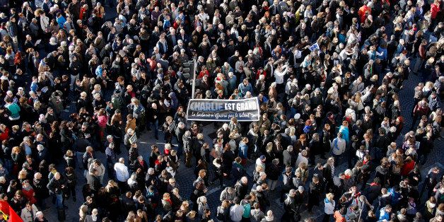 Demonstrators hold a banner reading "Charlie is great, barbarism will not erase talent" during a demonstration in solidarity with the victims of terrorist attacks in and around Paris linked to Wednesday's attack at French satirical newspaper Charlie Hebdo at the Old-Port of Marseille, southern France, Saturday, Jan. 10, 2015. Hundreds of thousands of people marched Saturday in cities from Toulouse in the south to Rennes in the west to honor the 17 victims of three attackers, killed by police after three days of bloodshed at the offices of a satirical newspaper, a kosher supermarket and other sites around Paris. (AP Photo/Claude Paris)