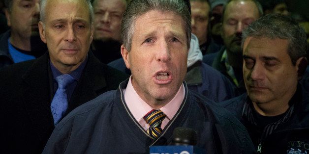ADDS BOTH OFFICERS KILLED - Patrick Lynch, head of the Patrolmen's Benevolent Association, speaks during a news conference after the bodies of two fallen NYPD police officers were transported from Woodhull Medical Center, Saturday, Dec. 20, 2014, in New York. An armed man walked up to two New York Police Department officers sitting inside a patrol car and opened fire Saturday afternoon, killing both officers before running into a nearby subway station and committing suicide, police said. (AP Photo/John Minchillo)
