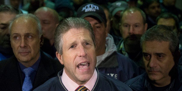 Patrick Lynch, head of the Patrolmen's Benevolent Association, speaks during a news conference after the bodies of two fallen NYPD police officers were transported from Woodhull Medical Center, Saturday, Dec. 20, 2014, in New York. An armed man walked up to two New York Police Department officers sitting inside a patrol car and opened fire Saturday afternoon, killing one and critically wounding a second before running into a nearby subway station and committing suicide, police said. (AP Photo/John Minchillo)