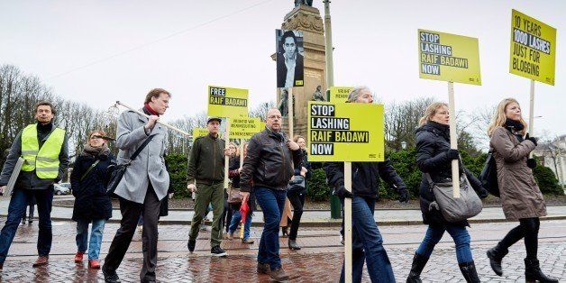 People take part in a protest by Amnesty International, for the immediate release of the Saudi blogger Raif Badawi, in front of the Saudi Embassy in The Hague, on January 15, 2015. Badawi put on the website 'Freed Saudi liberals 'and was arrested in 2012. He was sentenced to ten years in prison, converted 226,000 euro fine and a thousand lashes. AFP PHOTO / ANP / MARTIJN BEEKMAN ***netherlands out*** (Photo credit should read Martijn Beekman/AFP/Getty Images)