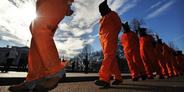 Activists dressed as Guantanamo Bay detainees march during a demonstration organized by Witness Against Torture in front of the White House in Washington, DC, on January 11, 2010. Activists and Guantanamo lawyers took part in the demonstration to mark the eighth anniversary of the opening of the US prison in Guantanamo Bay, Cuba. US President Barack Obama renewed his vow to close the Guantanamo Bay jail despite deciding to suspend transfers of prisoners to Yemen following the Christmas Day airliner attack. AFP PHOTO/Jewel SAMAD (Photo credit should read JEWEL SAMAD/AFP/Getty Images)