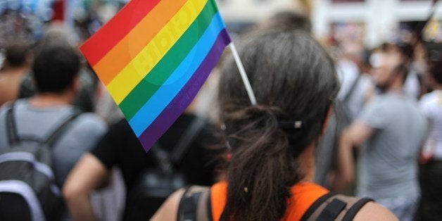 A participant wears a Rainbow flag while taking part in the Gay Pride homosexual, bisexual and transgender visibility march on June 14, 2014, in Nantes, western France. Drag queens, civil rights activists and scantily clad gay and straight couples made their way through the city to the thumping of dance music. AFP PHOTO / JEAN-SEBASTIEN EVRARD (Photo credit should read JEAN-SEBASTIEN EVRARD/AFP/Getty Images)