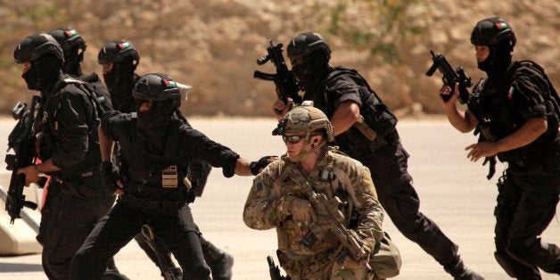 FILE - In this Thursday, June 20, 2013 photo, special operations forces from Iraq, Jordan and the U.S. conduct an exercise as part of Eager Lion multinational military maneuvers at the King Abdullah Special Operations Training Center (KASOTC) in Amman, Jordan. Jordan says it is ready to host U.S. training of Iraqi soldiers after al-Qaida militants seized control of two towns in its contested Anbar province. Information Minister Mohammad Momani said Sunday that Jordan has received a U.S. request to host the training and that details are being discussed. (AP Photo/Maya Alleruzzo, File)