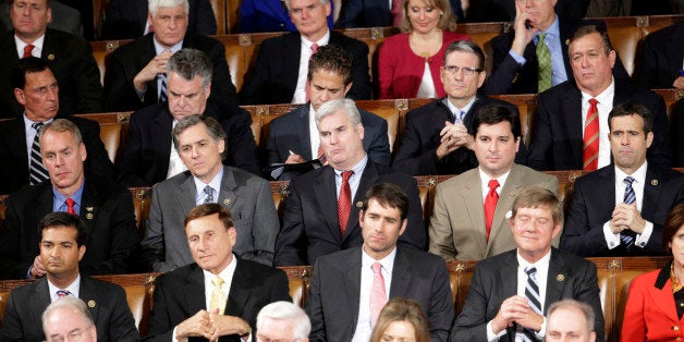 Republican members of Congress listen during President Baracl Obama's State of the Union address before a joint session of Co