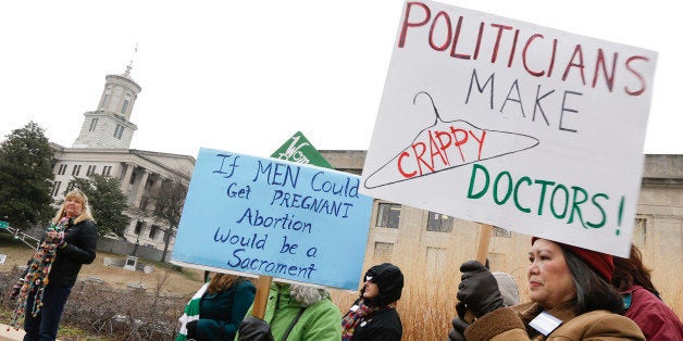 Meryl Woo Rice, right, takes part in an abortion rights protest near the Capitol on the opening day of the second session of the 109th General Assembly, Tuesday, Jan. 13, 2015, in Nashville, Tenn. (AP Photo/Mark Humphrey)