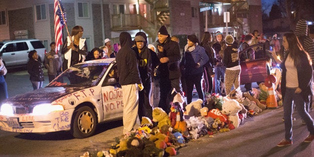 FERGUSON, MO - JANUARY 19: Demonstrators protest next to the Michael Brown memorial on Martin Luther King Jr. Day January 19, 2015 in Ferguson, Missouri. Brown, an unarmed black teenager, was shot and killed by Darren Wilson, a white Ferguson police officer August 9, 2014. His death caused months of sometimes violent protests in the St. Louis area and sparked nationwide outcry against use of excessive force by police. (Photo by Scott Olson/Getty Images)