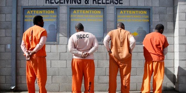 In this photo taken Thursday, Feb. 20, 2014, prisoners from Sacramento County await processing after arriving at the Deuel Vocational Institution in Tracy, Calif. California counties are thwarting the state's efforts to comply with a federal court order to reduce it's inmate population by sending state prisons far more convicts than anticipated including a record number of second-strikers. The state is trying to comply with a landmark restructuring of its criminal justice system through a nearly 3-year-old law pushed by Gov. Jerry Brown that keeps lower-level felons in county jails while reserving scarce state prison cells for serious, violent and sexual offenders.(AP Photo/Rich Pedroncelli)