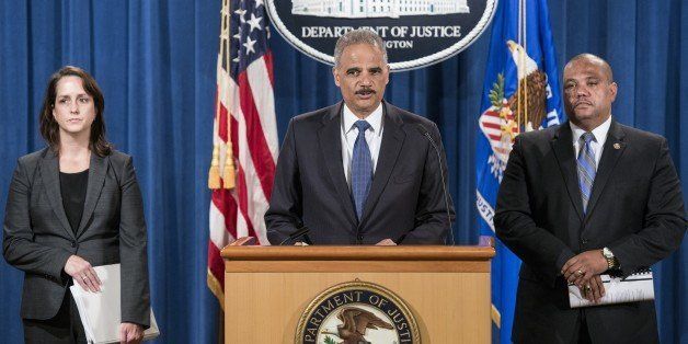 Molly Moran (L), acting Assistant Attorney General for the Civil Rights Division, and Ronald Davis (R), COPS Director, listen as US Attorney General Eric Holder speaks during a press conference at the Department of Justice September 4, 2014 in Washington, DC. US Attorney General Holder announced the departments intent to further investigate civil rights violations by the Ferguson, Missouri police department with the possibility of expanding the investigation to other Saint Louis County departments. AFP PHOTO/Brendan SMIALOWSKI (Photo credit should read BRENDAN SMIALOWSKI/AFP/Getty Images)