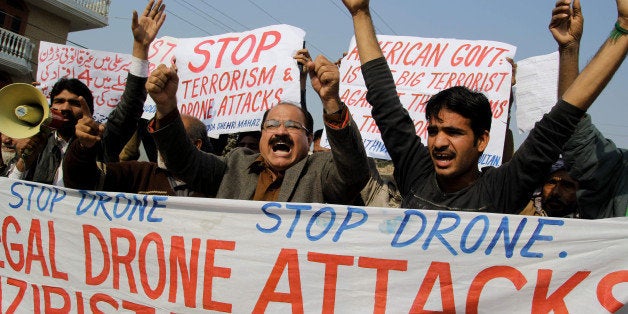 Activists from the Muttahida Shehri Mahaz shout slogans as they protest against a US drone attack in Multan on December 26, 2103. A US drone strike targeting a militant compound killed at least three suspected insurgents in a restive Pakistani tribal region near the Afghan border late December 25, officials said. AFP PHOTO/S S MIRZA (Photo credit should read S S MIRZA/AFP/Getty Images)