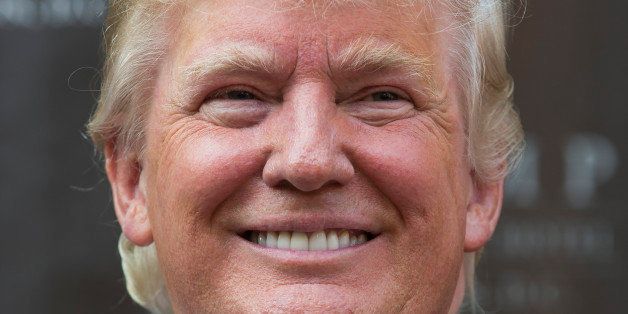 Donald Trump smiles during a ground breaking ceremony for the Trump International Hotel on the site of the Old Post Office, on Wednesday, July 23, 2014, in Washington. (AP Photo)