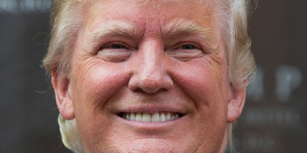 Donald Trump smiles during a ground breaking ceremony for the Trump International Hotel on the site of the Old Post Office, o