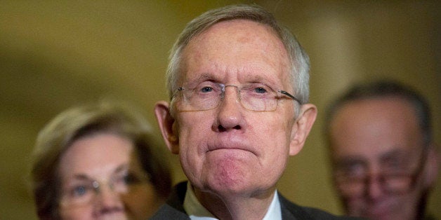 Senate Majority Leader Harry Reid, a Democrat from Nevada, pauses while speaking during a news conference with Senator Elizabeth Warren, a Democrat from Massachusetts, left, and Senator Charles Schumer, a Democrat from New York, following a private meeting at the U.S. Capitol Building in Washington, D.C., U.S., on Thursday, Nov. 13, 2014. U.S. Senate Democrats plan to elevate first-term Massachusetts Senator Elizabeth Warren to their leadership ranks on an expanded communications and policy committee led by third-ranking Democrat Charles Schumer. Photographer: Andrew Harrer/Bloomberg via Getty Images 