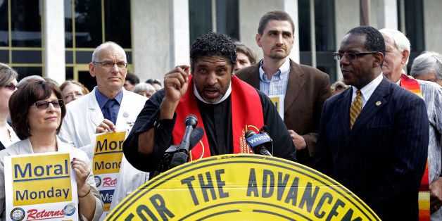 Rev. William Barber, President of the North Carolina NAACP speaks during a news conference outside the legislative office building prior to the opening session of the General Assembly in Raleigh, N.C., Wednesday, May 14, 2014. (AP Photo)