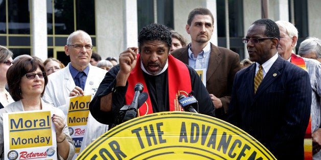 Rev. William Barber, President of the North Carolina NAACP speaks during a news conference outside the legislative office bu