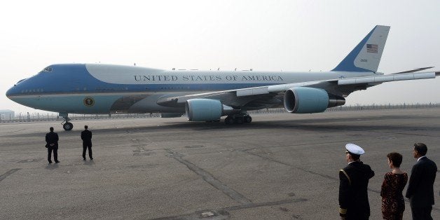 The US embassy defence attache salutes as the Air Force One aircraft prepares to taxi with US President Barack Obama and his